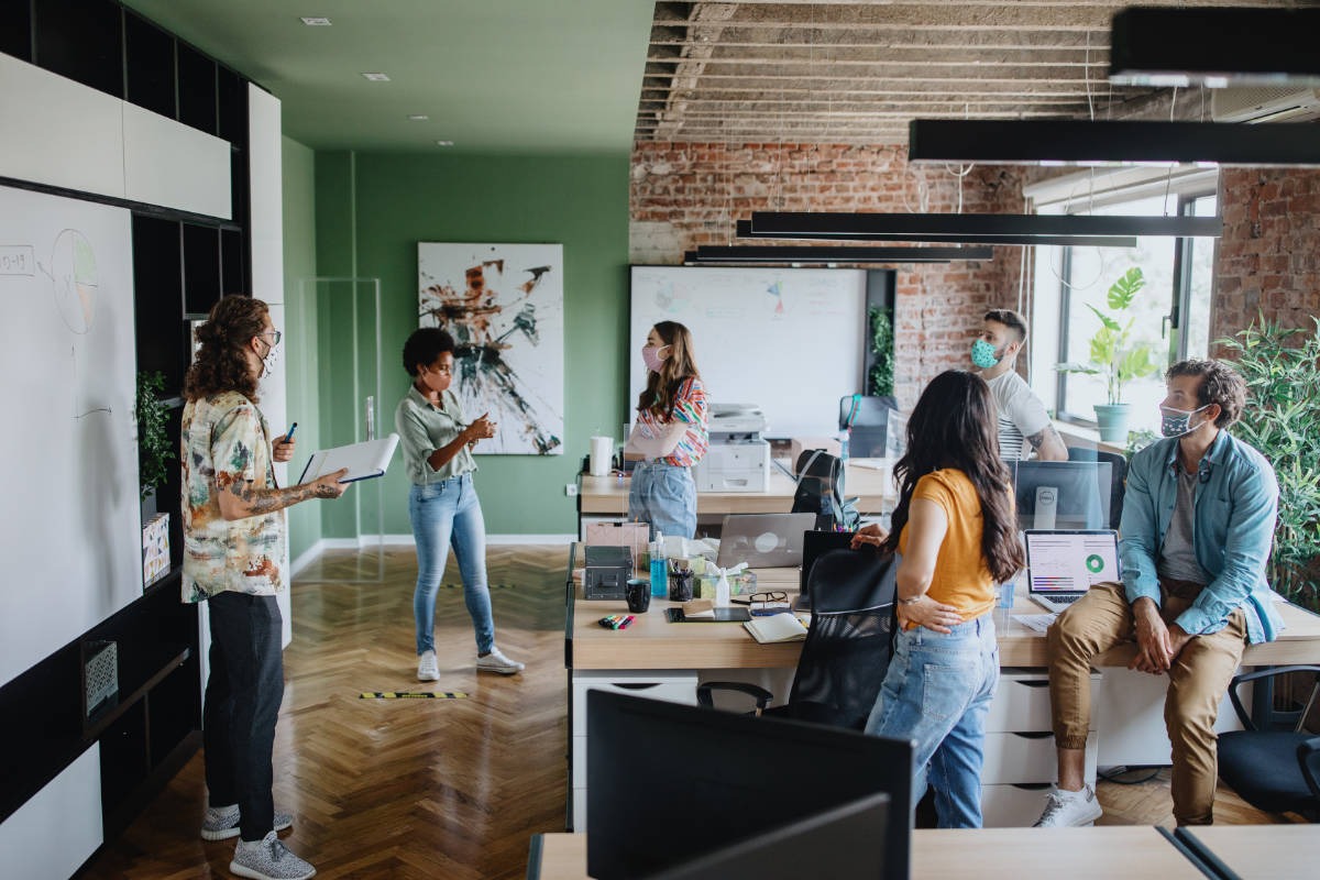 Office staff respecting social distancing during a meeting