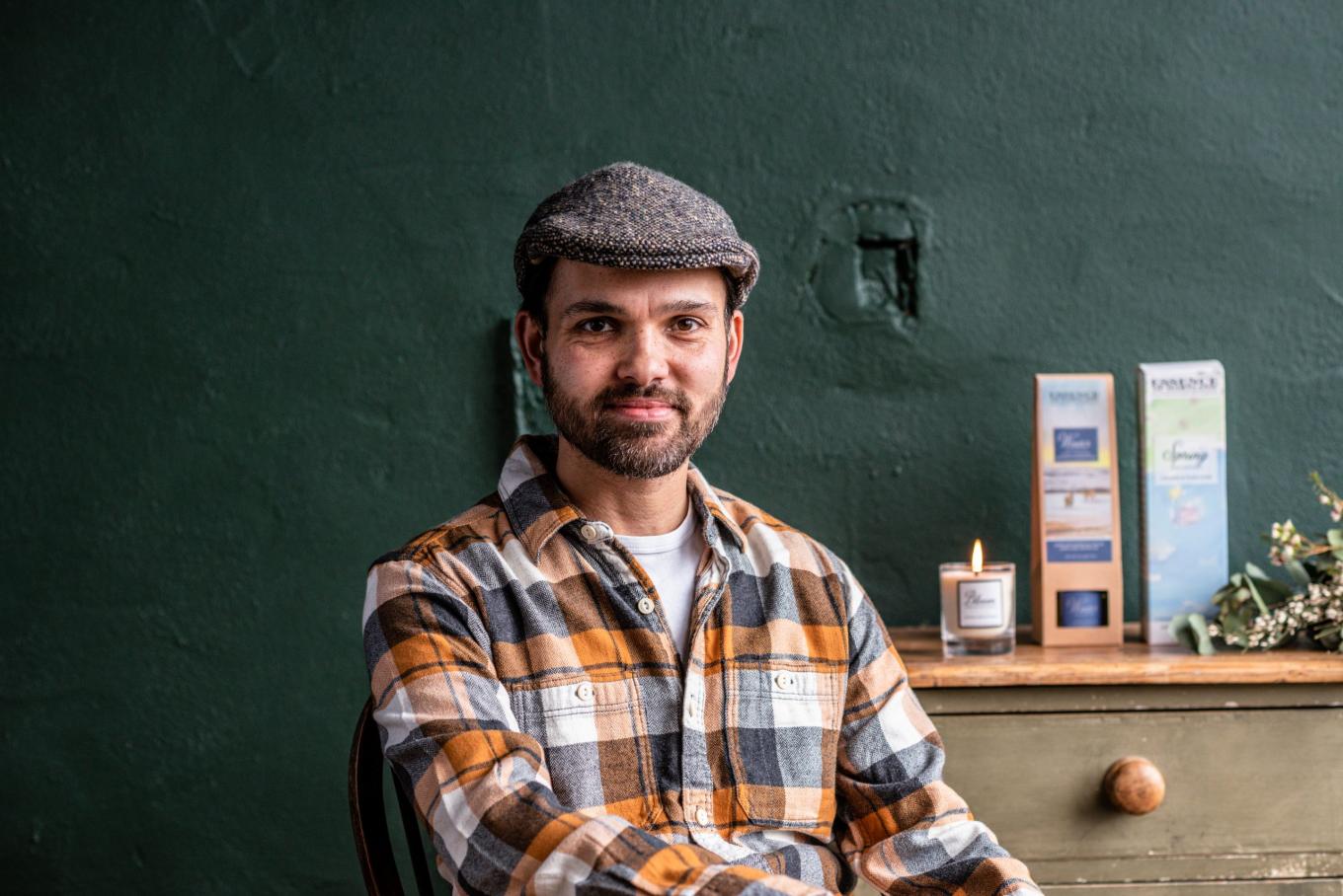 A man wearing a hat and plaid shirt