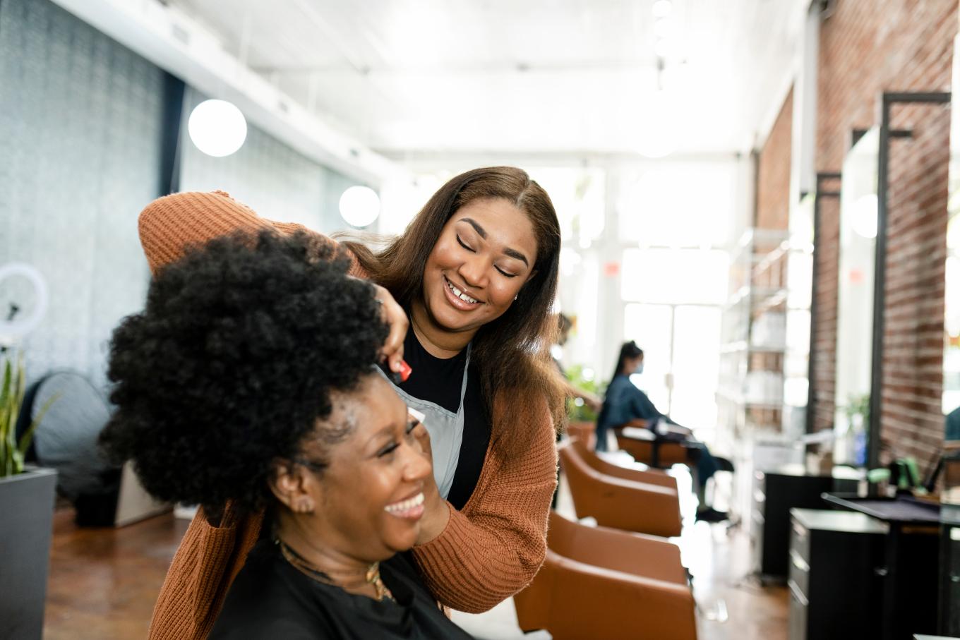 Female hairdresser cutting hair