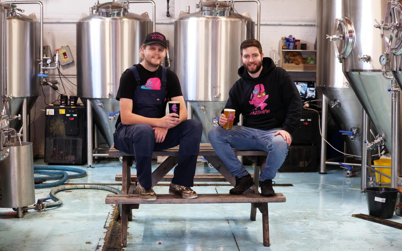 2 men sat in a brewery factory