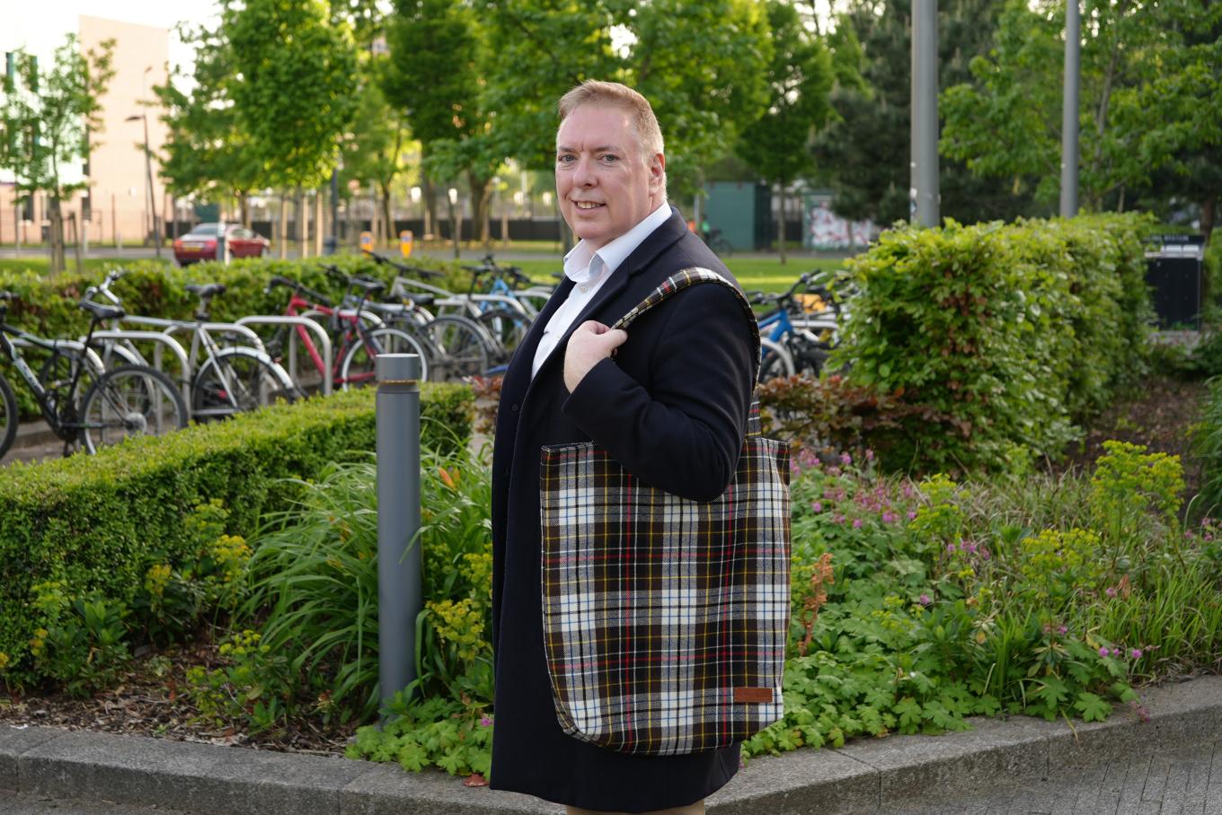 Founder George Greer holding his sustainable dog waste bags