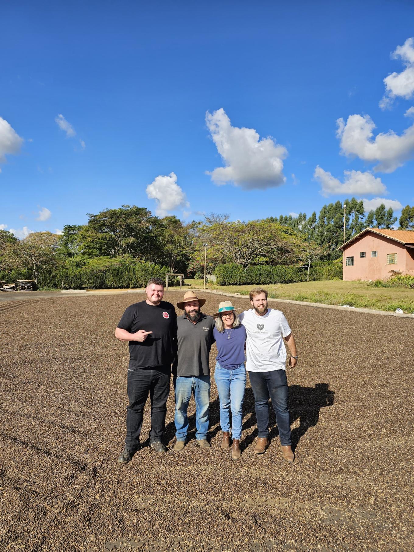 coffee farmers standing a plot of field 