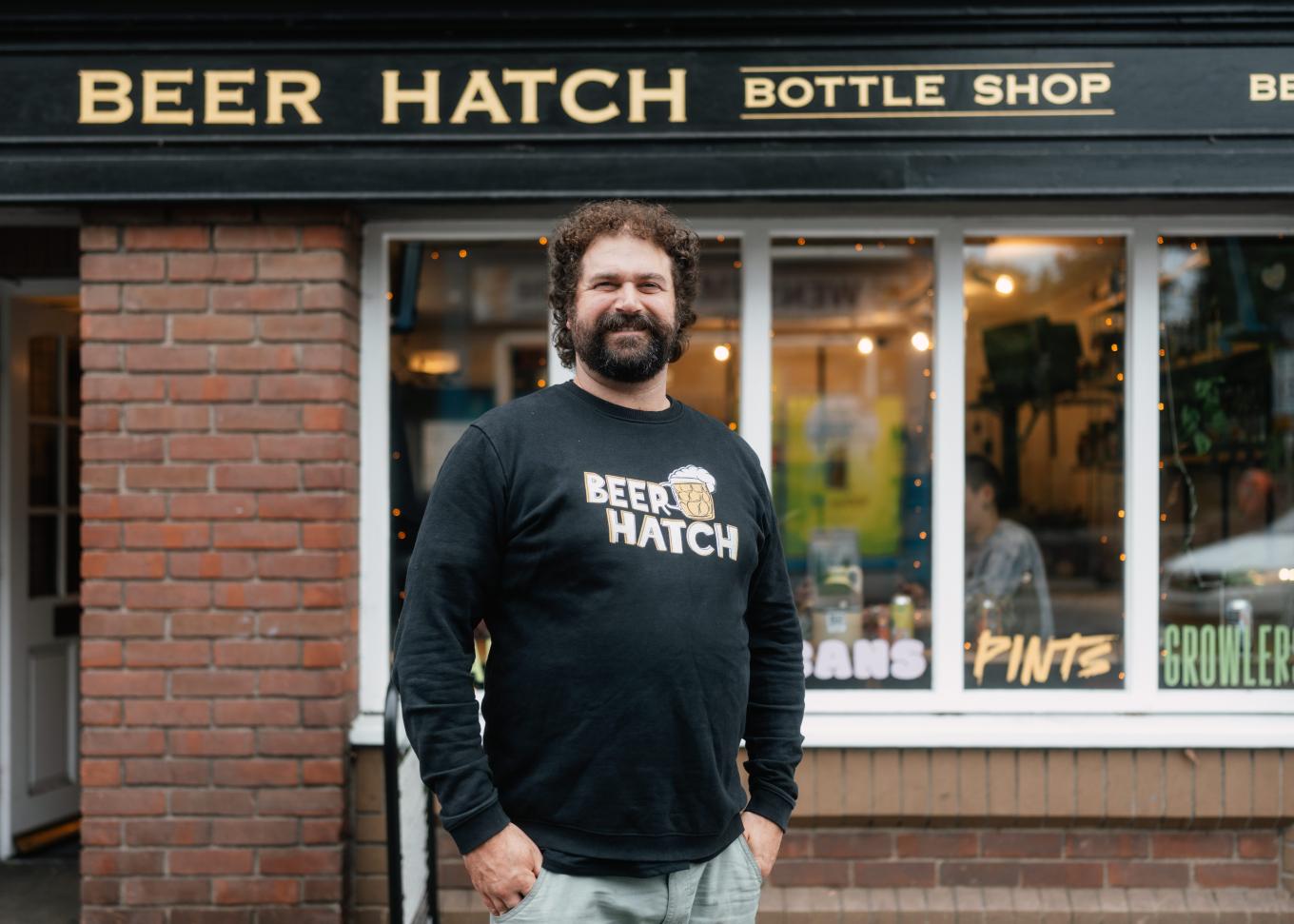 Saul Press founder of Beer Hatch outside his business