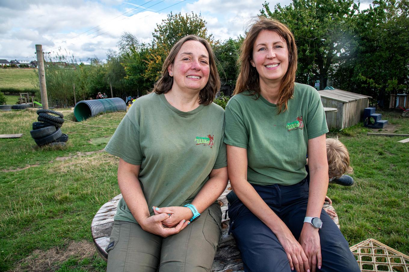 Founders of Growig Wild sitting outside a play area