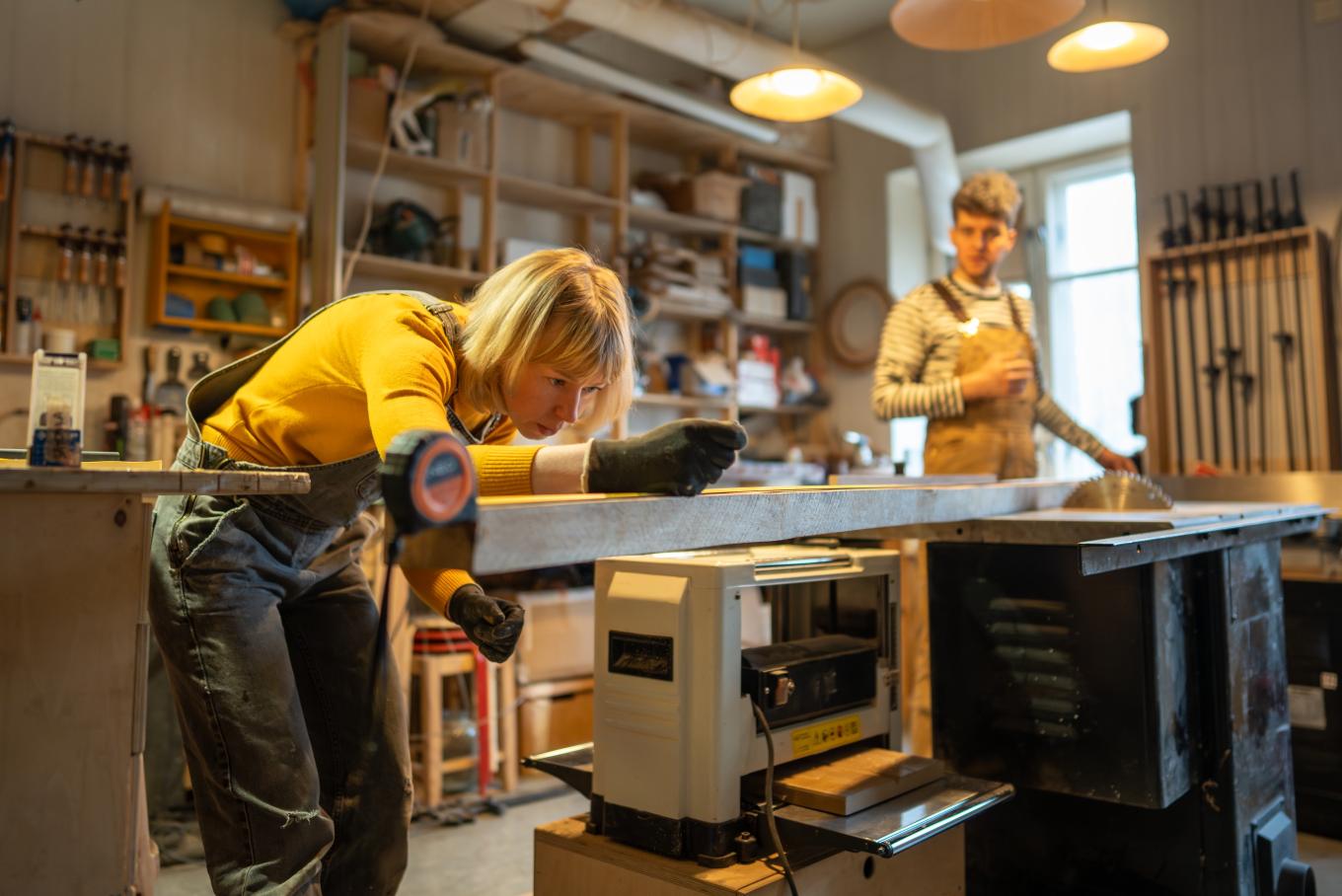 A female metal worker technical in a workshop environment