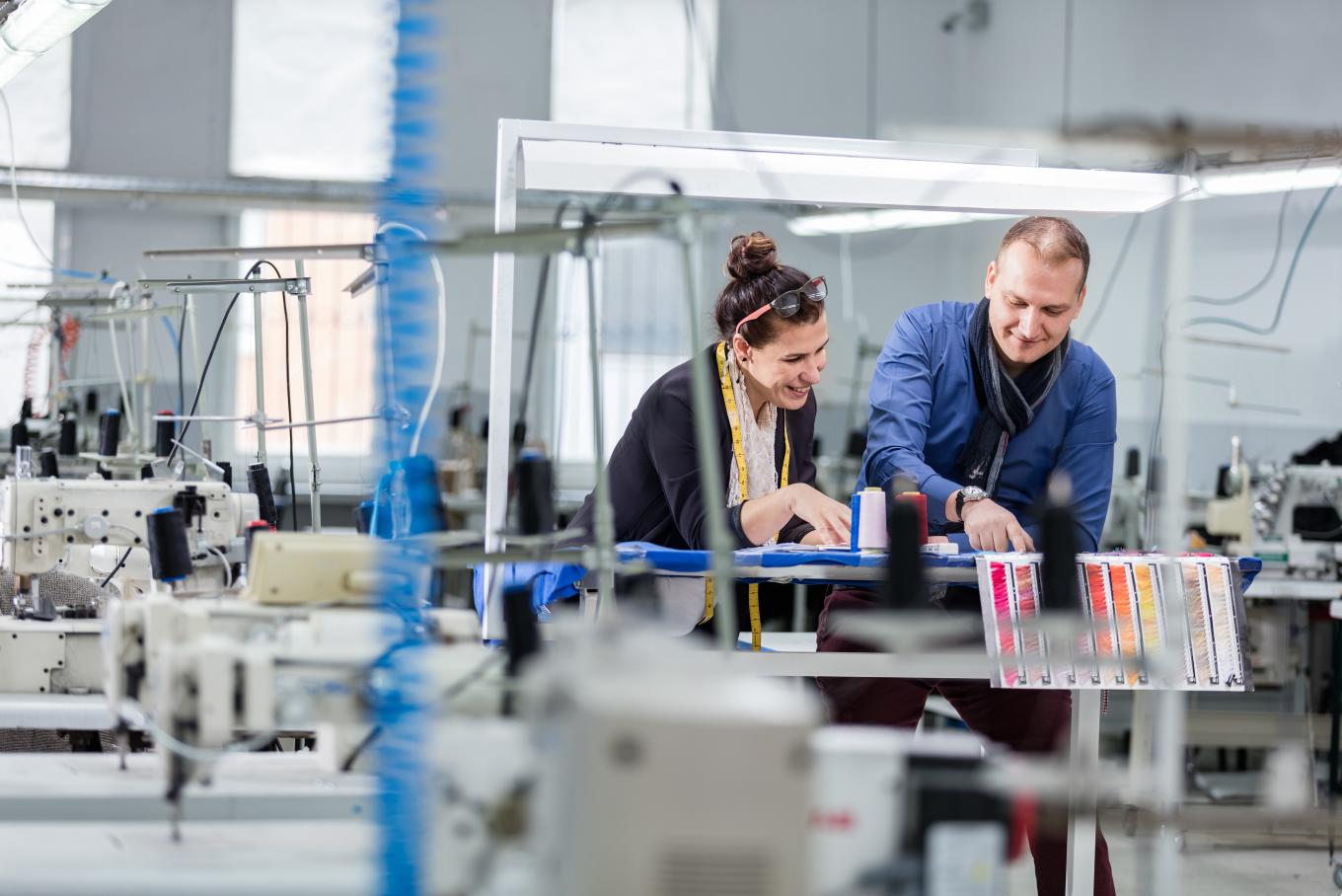 A male and female working in a paint factory 