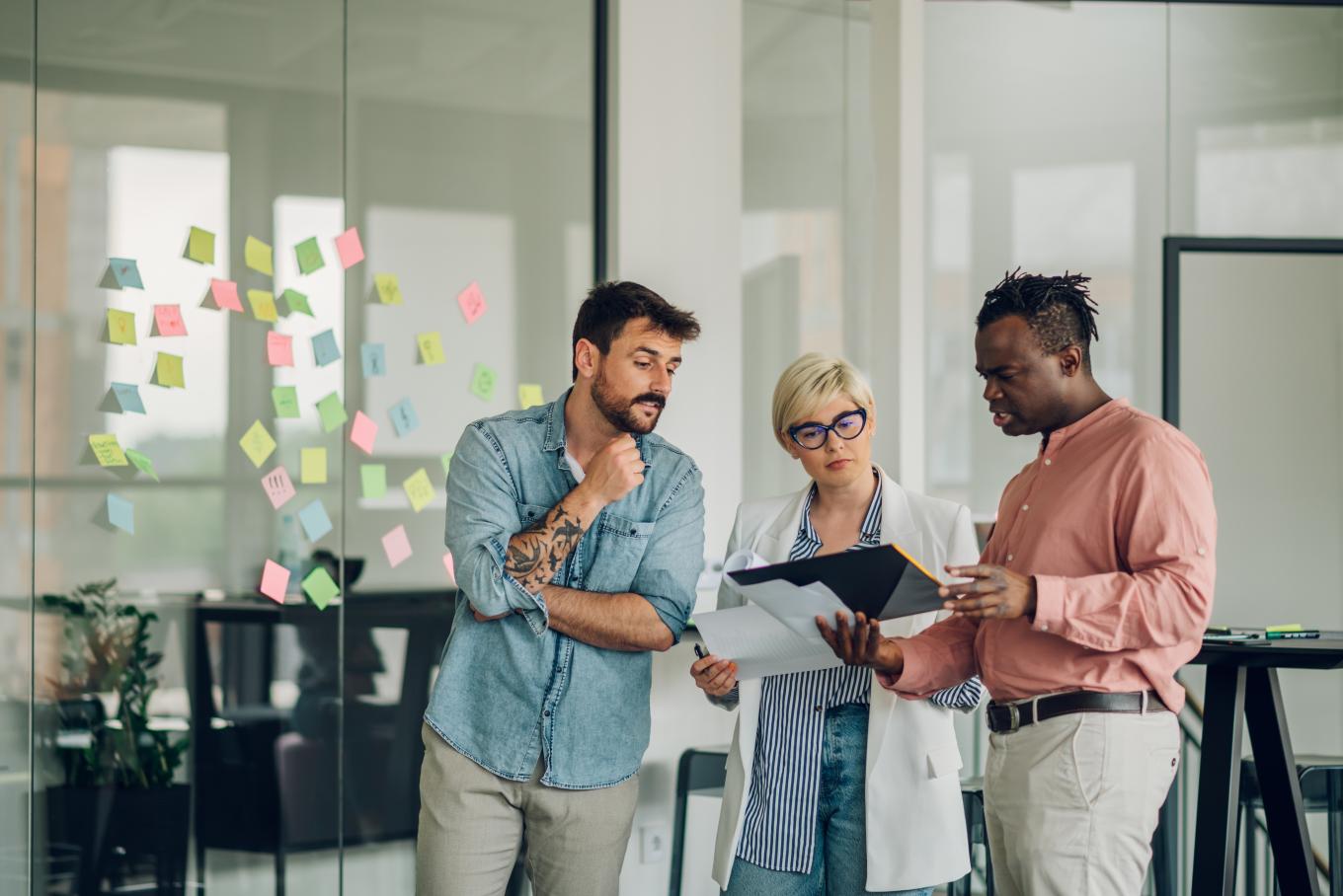 A brainstorming session in the office made up of two males and a female 